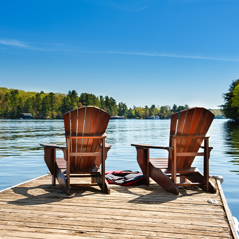 two chairs on a dock facing a lake_480x480_1