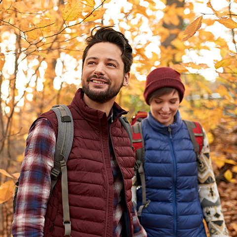 couple hiking in the woods during fall