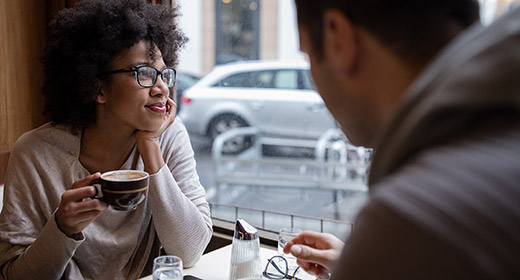 Man and woman sitting in a cafe and enjoying coffee together